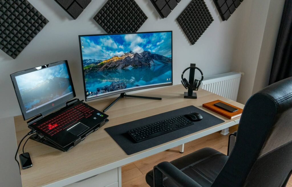 black and silver laptop computer on brown wooden table